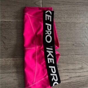 Short hot pink Nike Pro shorts.
